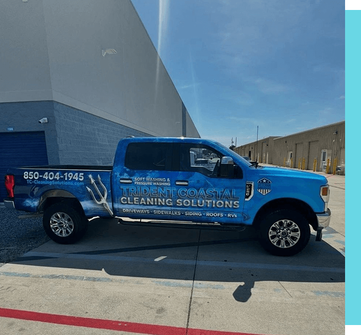 A blue truck parked in front of a building.